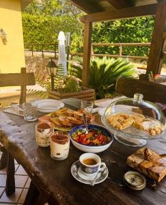 a wooden table with food and coffee on it at Il Nido di Zia Mina in Formia