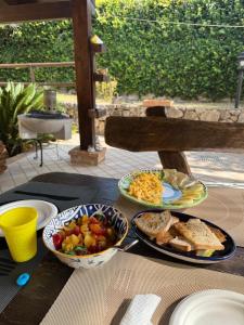 a table with plates of food and bread and toast at Il Nido di Zia Mina in Formia +3 photos