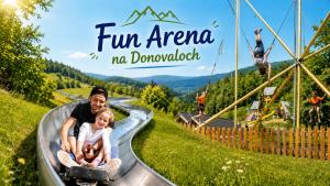 a man and a child riding a skateboard down a roller coaster at Kamzík Apartment 64 Donovaly - hneď pri lanovke a atrakciách Donovalkovo, Fun arena - Apartment near the cable car and attractions in Donovaly