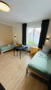 a bedroom with a bed and a table and a window at Aparthotel Grünewald in Hannover +35 photos