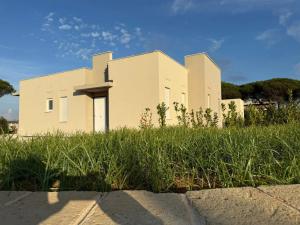 a building on top of a field of grass at Residence Niko 5 Pomezia in Pratica di Mare
