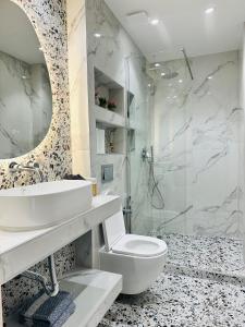 a bathroom with a sink and a toilet and a shower at Sunny Siviri in Siviri +43 photos