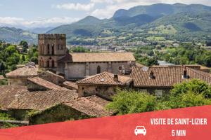 a group of buildings with mountains in the background at " Loutrein Lodge " Centre ville - Entrée autonome - Wifi in Saint-Girons