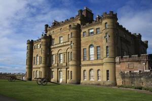 a large castle with benches in front of it at The Wee Shore House in Ayr