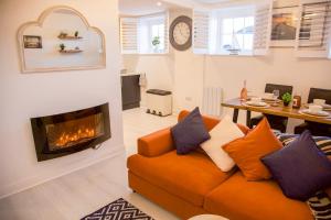 a living room with a couch and a fireplace at The Wee Shore House in Ayr