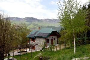 a house with solar panels on top of it at Vila Teodora in Mojkovac