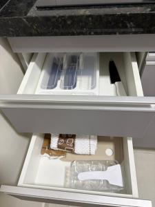 an open drawer in a kitchen with a counter top at Residencial Bom Sossego Apto 01 in Itabuna