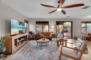 a living room with a couch and a ceiling fan at Cactus Retreat Pool Fire Pit Pet Friendly in Green Valley
