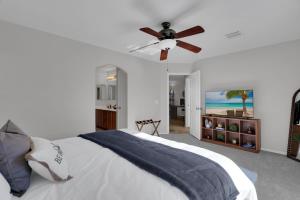 a bedroom with a bed with a ceiling fan at Cactus Retreat Pool Fire Pit Pet Friendly in Green Valley +29 photos