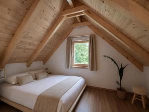 a bedroom with a large bed and a window at BaLOVEon Birtok in Káptalantóti