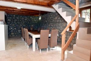 a dining room with a table and chairs at Vila Teodora in Mojkovac +11 photos