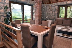 a dining room with a wooden table and chairs at Vila Teodora in Mojkovac