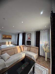 a living room with a couch and a bed at Vila Nikollaj in Kamëz