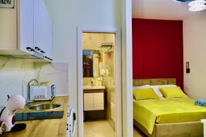 a small room with a bed and a sink at Demaj House in Grilë