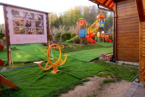 a play yard with a playground with a slide at Kedar selo Goč in Goč