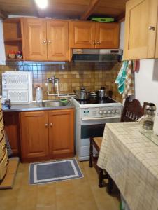 a small kitchen with a sink and a stove at Myrto's traditional house in Skiros