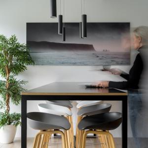 a woman sitting at a table with chairs at Storm Hotel by Keahotels in Reykjavík