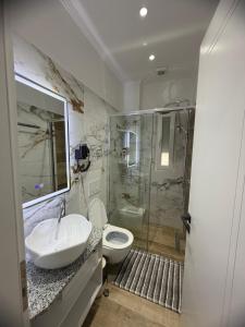 a bathroom with a sink and a toilet and a shower at Vila Nikollaj in Kamëz +54 photos