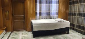 a small bed in a room with a window at Bliss Spa Gulshan - Spa in Gulshan in Bhola +2 photos