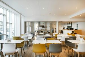 an empty restaurant with tables and chairs at Storm Hotel by Keahotels in Reykjavík