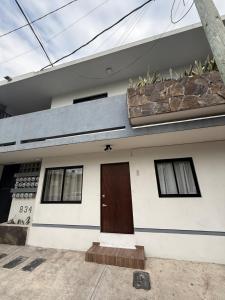a house with a brown door and windows at Nice downtown apartment Veracruz in Veracruz