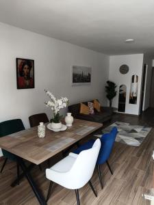 a living room with a wooden table and blue chairs at Nice downtown apartment Veracruz in Veracruz +17 photos