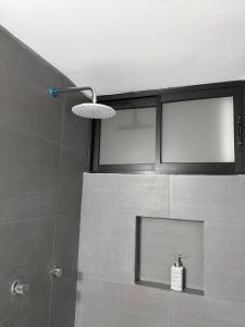a bathroom with a shower with a glass window at Nice downtown apartment Veracruz in Veracruz
