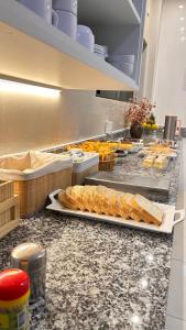 a kitchen with a bunch of food on a counter at Hotel Moriah in Umuarama