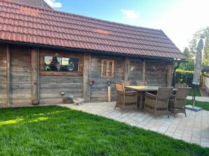 a patio with a table and chairs in front of a house at Appartement Gombotz in Halbenrain