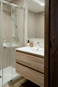 a bathroom with a sink and a glass shower at SuiteStays Marino Albesa - Ayora, Valencia in Valencia +271 photos