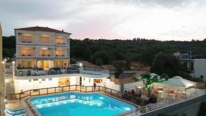 a view of a building with a swimming pool at CHIOS HOTEL in Katarráktis