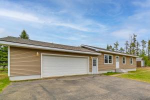 a house with a car garage in front of it at Explore the Upper Peninsula! Marquette Home in Marquette