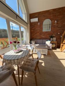a living room with a table and chairs at Polana House in Niedźwiada
