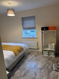 a bedroom with a bed and a window at Lion Gardens- The Space in Leyland