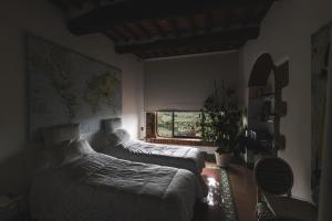 a bedroom with two beds and a window at Casa Marelli in Castelmuzio +74 photos