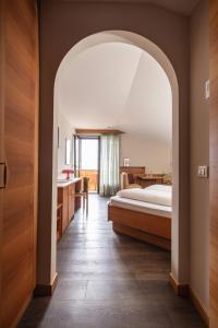 a bedroom with a bed and a bathroom at JOHAN - Rooms & Breakfast Merano in Marlengo +61 photos