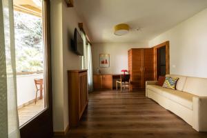 a living room with a couch and a window at JOHAN - Rooms & Breakfast Merano in Marlengo