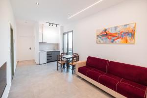 a living room with a red couch and a table at Riverside Villa in Tragjas