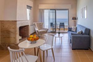 a living room with a couch and a fireplace at CHIOS HOTEL in Katarráktis