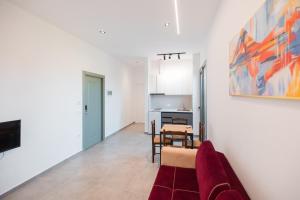 a living room with a couch and a kitchen at Riverside Villa in Tragjas