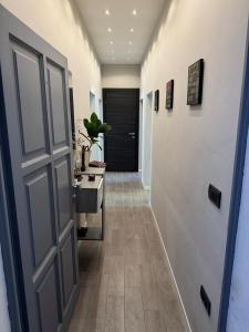 a hallway with a door and a bathroom with a sink at alloggioaltorrione in Citerna