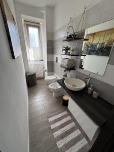 a bathroom with two toilets and a sink at alloggioaltorrione in Citerna