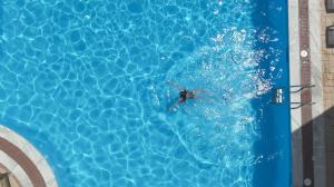 a person swimming in a swimming pool at CHIOS HOTEL in Katarráktis +50 photos