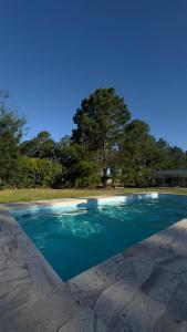a pool of blue water on a patio at Complejo ruka del pinar in San Ignacio