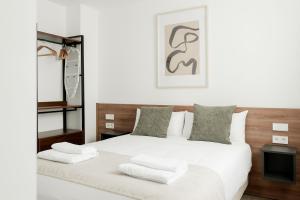 a bedroom with a large white bed with white pillows at SuiteStays Marino Albesa - Ayora, Valencia in Valencia