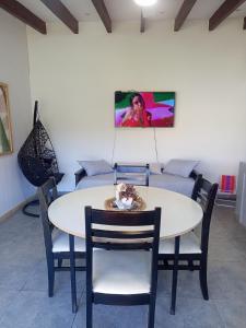 a dining room with a table and chairs and a couch at Hospedaje Atardeceres in San Fernando del Valle de Catamarca