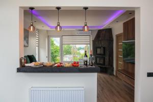 a kitchen with a table with food and lights at Villa Bellevue Genève in Annemasse