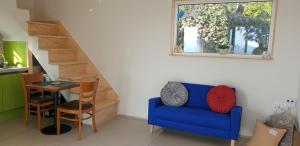 a living room with a blue couch and a table at Full Moon Dalbawi Pension in Jangheung