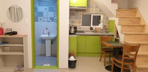 a small kitchen with a sink and a table at Full Moon Dalbawi Pension in Jangheung