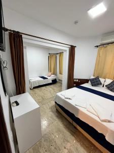 a bedroom with two beds and a mirror at Han Dalyan Hotel in Dalyan +46 photos